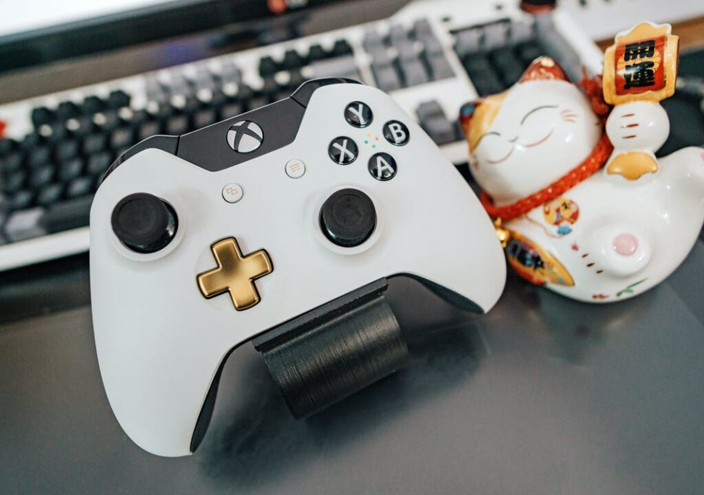 Xbox controller and a cute ceramic cat with Chinese character.