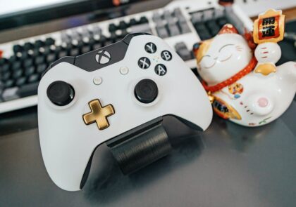 Xbox controller and a cute ceramic cat with Chinese character.