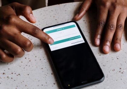 Kuvituskuva jossa näkyy kännykkä sekä sitä näpyttävät sormet.