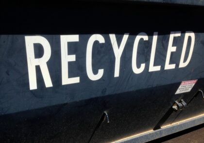 A black recycling vehicle