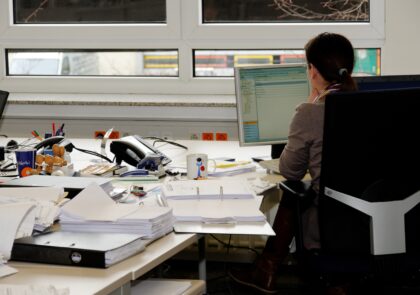 A worker is working with computer in an office.