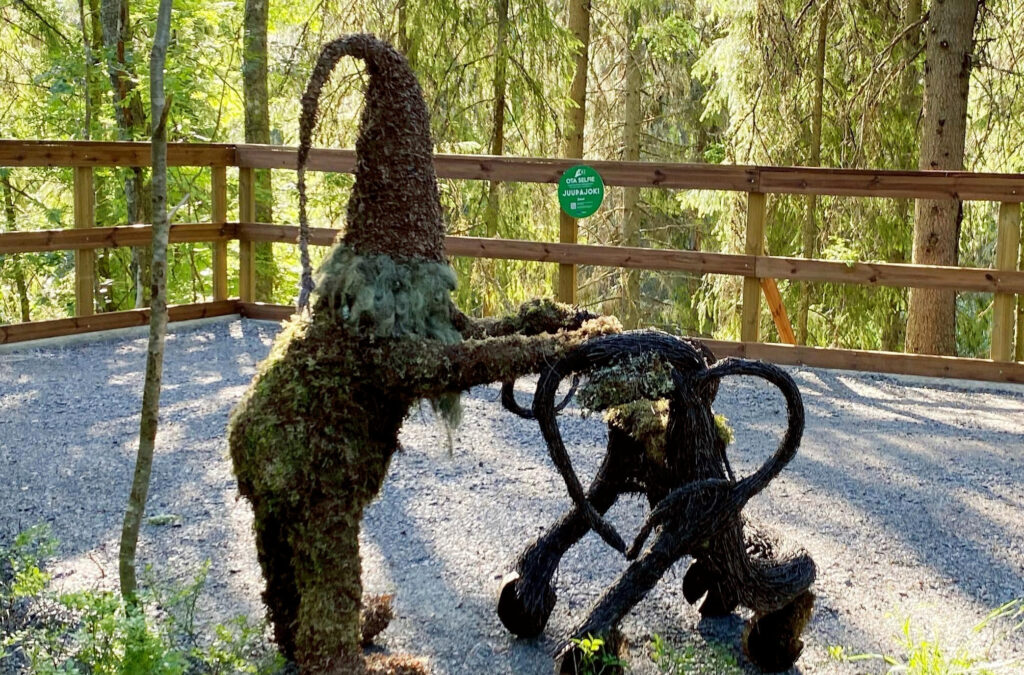 A moss elf pushing a rollator made of natural materials.