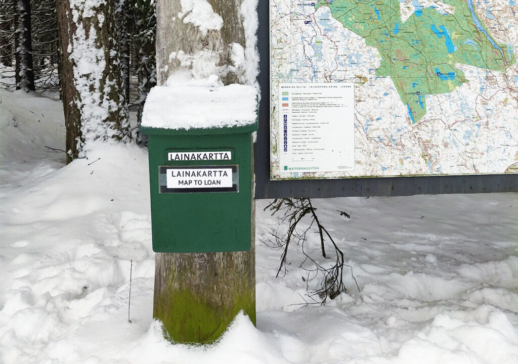 An illustration shows a mailbox for the map to loan at the entrance of Helvetinjärvi national park.