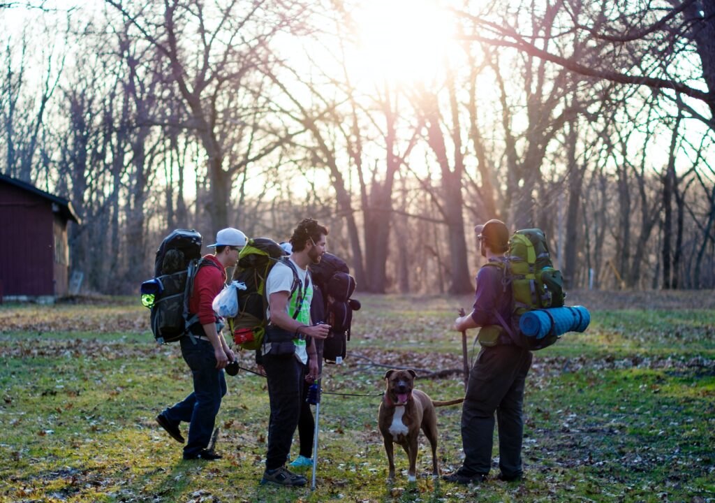 A group of people in a forest with a dog.