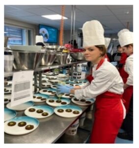 Students cook in the kitchen.